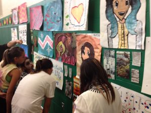 Students check out each others work during the Art Walk. Photo Jennifer Jessum.