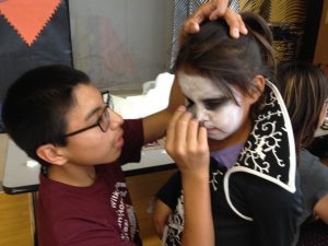 Students help get the monsters ready for filming. Photo Mary Gleason.