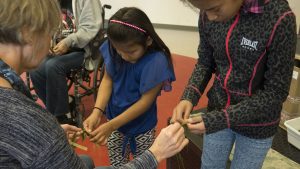 Braiding the sweetgrass for our art/service project. All the sweetgrass grown and donated by our friend Vanne Mocilac! Photo Sandhya Ramachandran. 